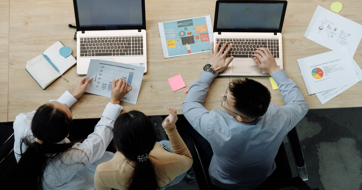team reviewing AI pilot results on charts