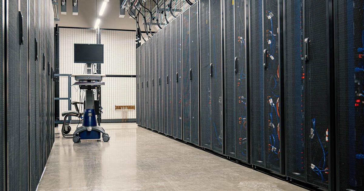rows of server cabinets in a data centre corridor where PHP runs, the layer the PHP2Shell vulnerability affects